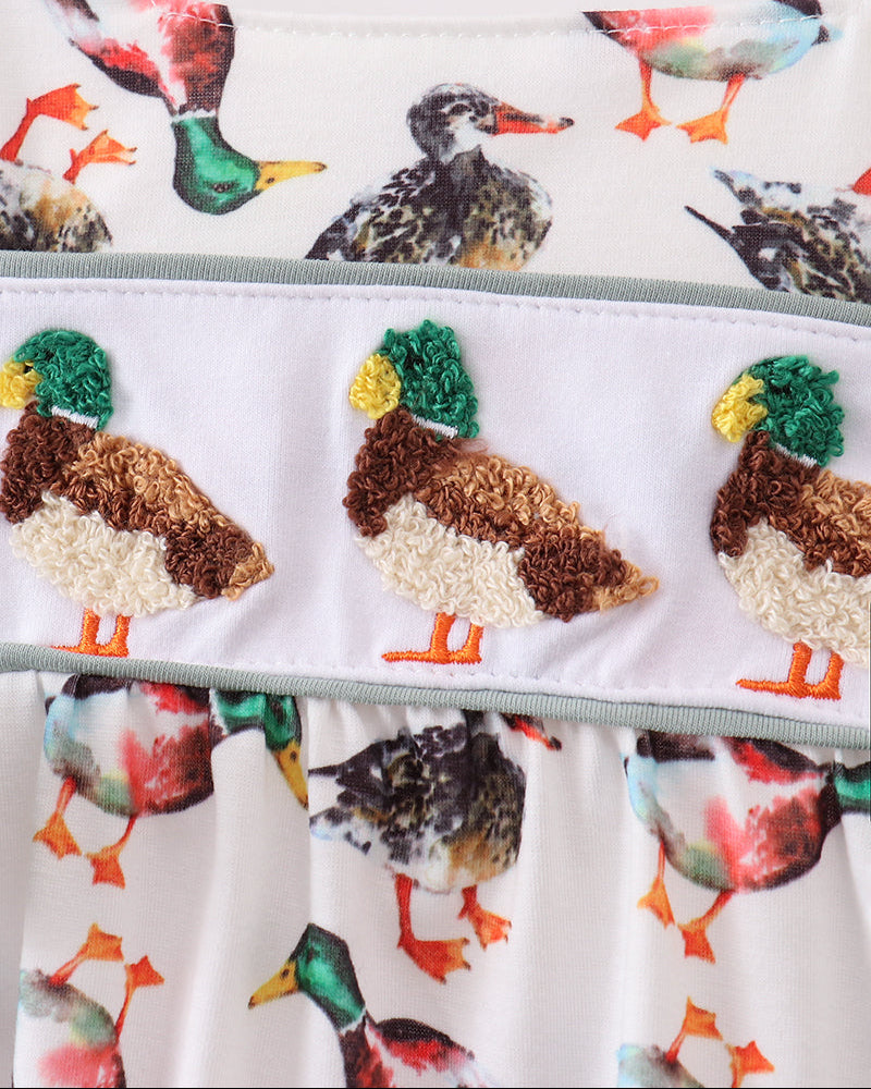 Infant romper close-up: multicolor bird print ruffles with duck applique and elastic waist