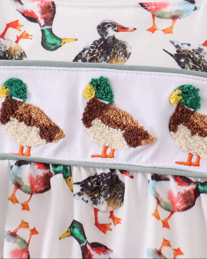 Infant romper close-up: multicolor bird print ruffles with duck applique and elastic waist