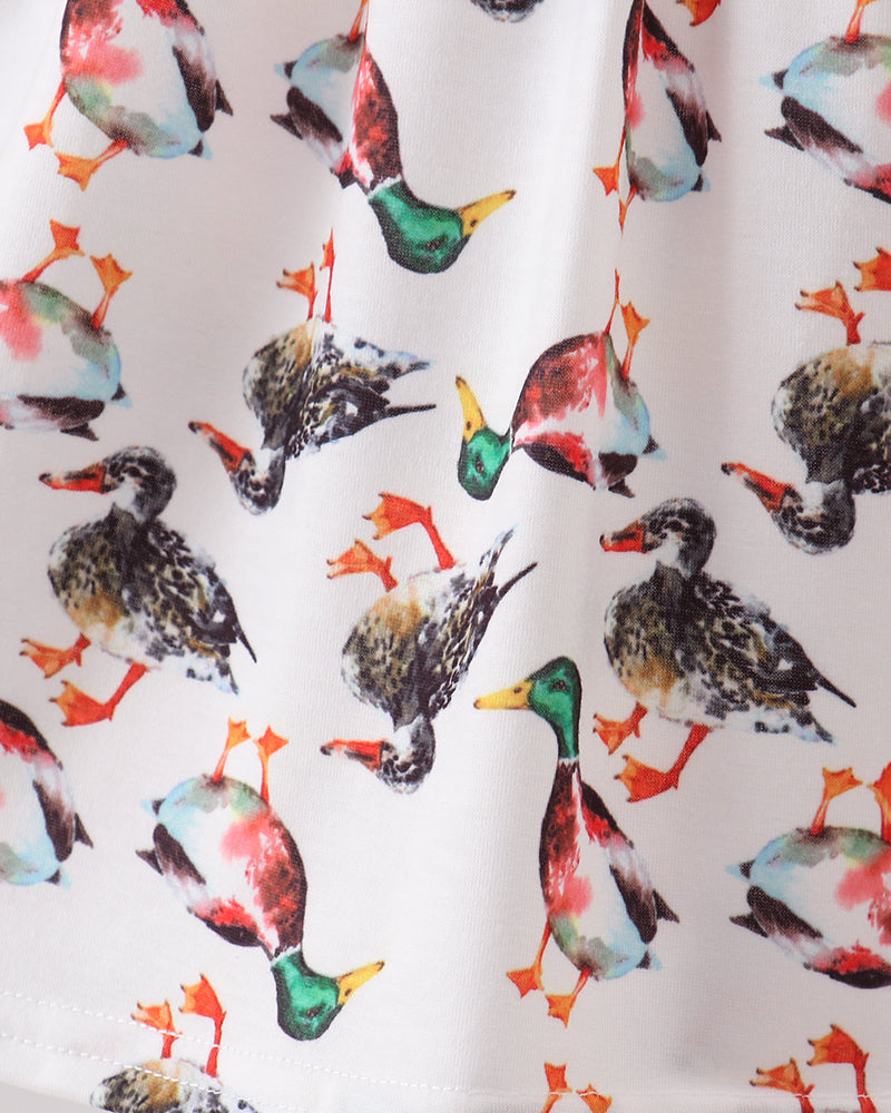 White bird-print dress fabric with ruffled hem edge