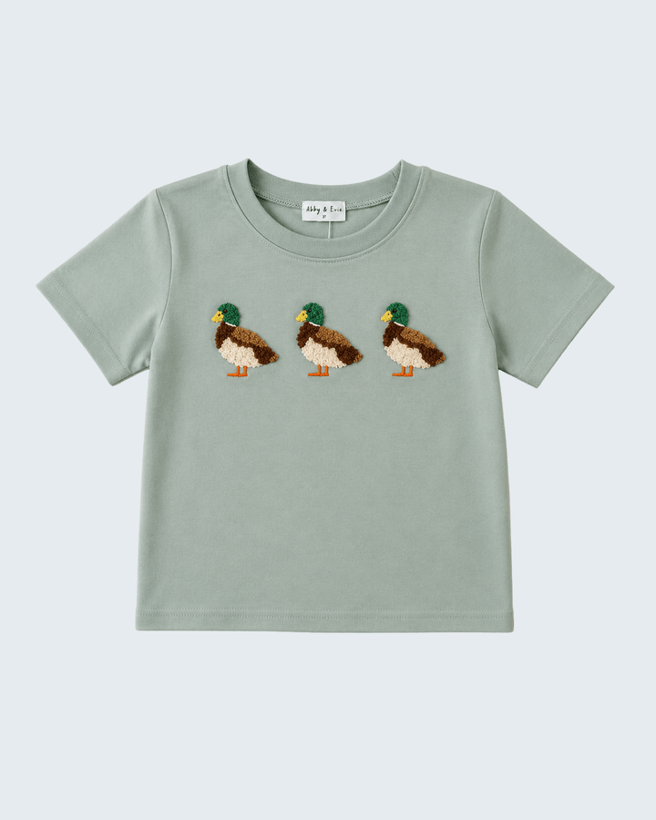 A light sage green short-sleeve baby t-shirt featuring three embroidered mallards across the chest, displayed flat against a light gray background.