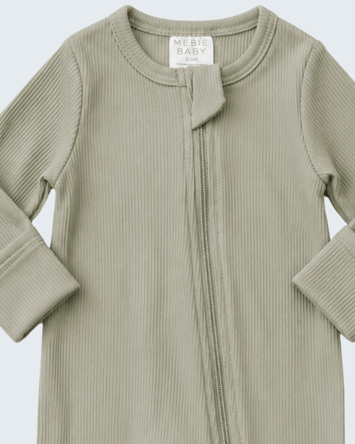 Ribbed organic cotton romper with stand collar and front zipper; long sleeves