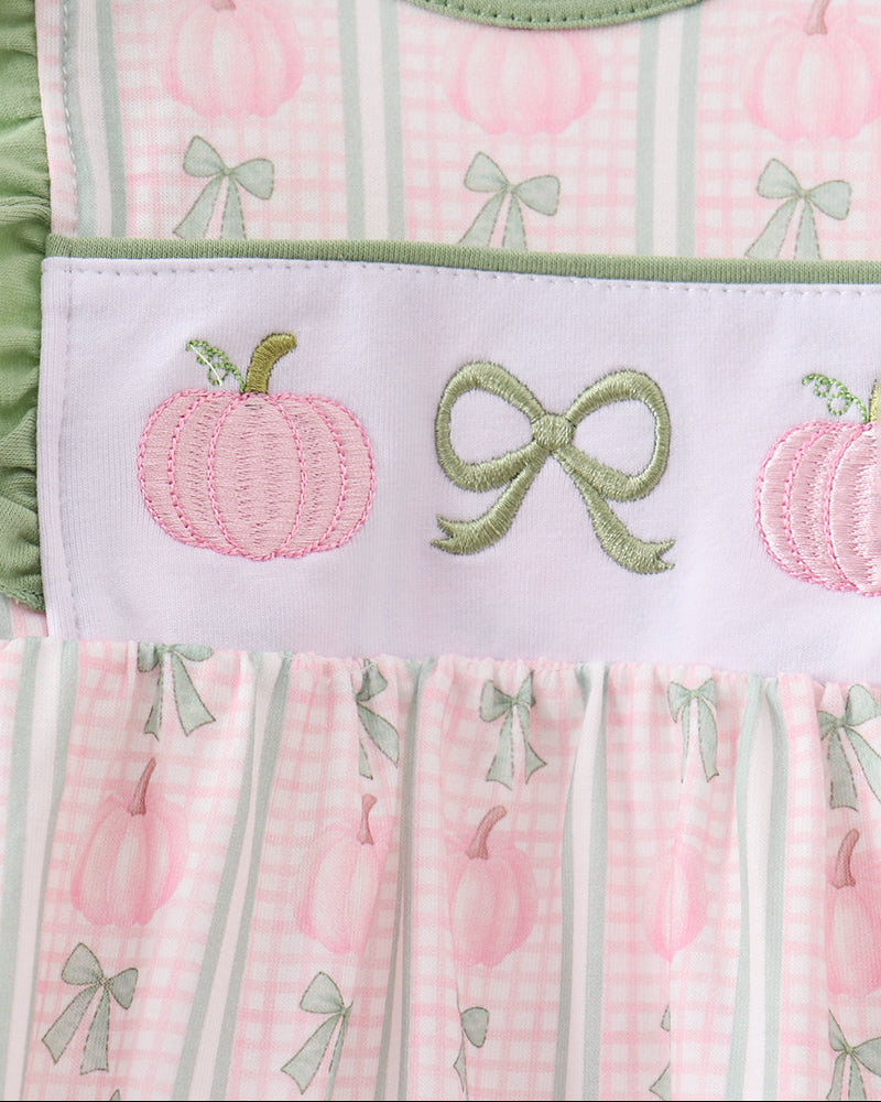 Chest embroidery detail: pink pumpkins and green bows on pink plaid baby dress bodice