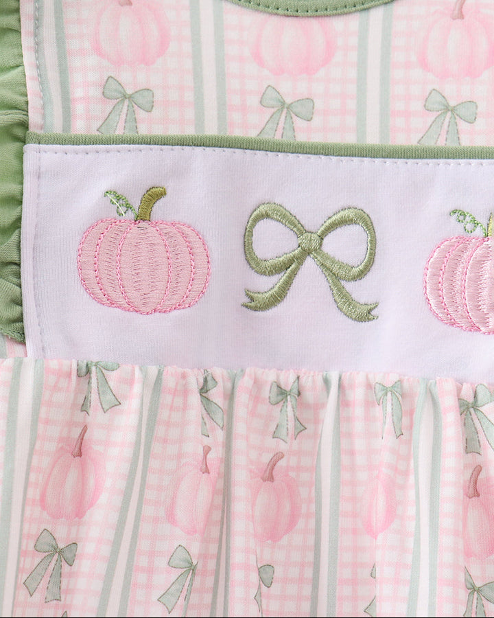 Chest embroidery detail: pink pumpkins and green bows on pink plaid baby dress bodice
