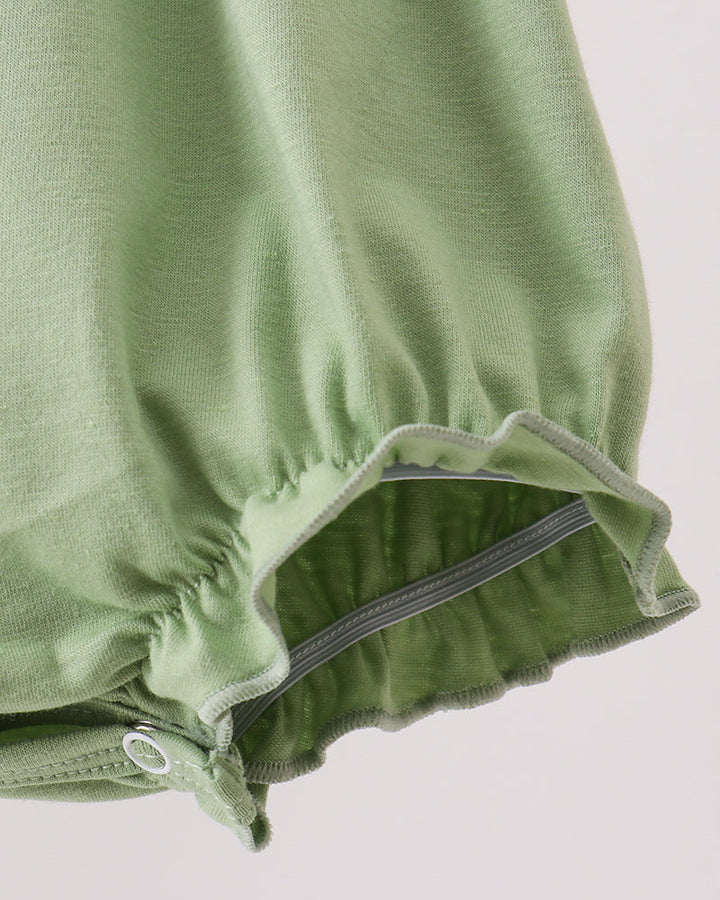 Green romper hem with ruffled edge and elastic leg opening