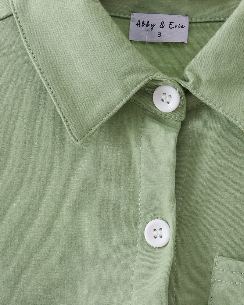 Sage green button-down shirt closeup: pointed collar, placket buttons, stitched seams