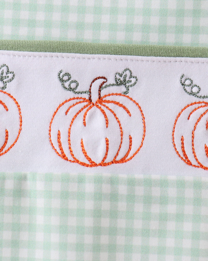 Pumpkin-themed embroidery on sage gingham romper with orange and green accents