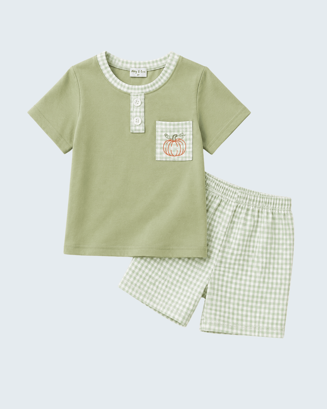 A baby boy's two-piece shorts set featuring a sage green short-sleeve henley shirt with a gingham-trimmed collar and chest pocket, and matching gingham shorts, displayed on a light gray background.
