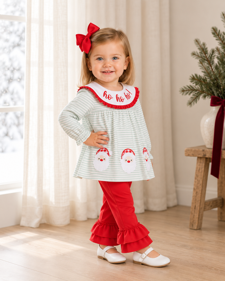 Toddler wearing mint striped Santa top with red ruffle collar and red ruffle pants