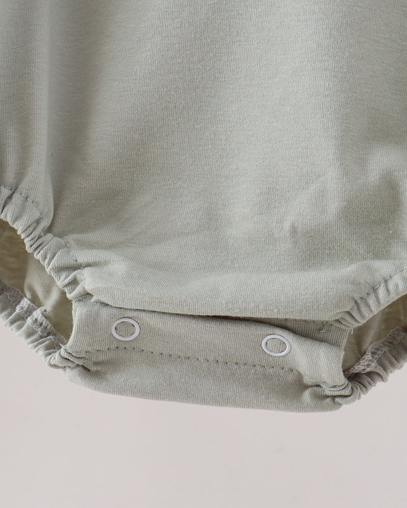 Sage green bubble romper with elastic leg gathers and snap buttons