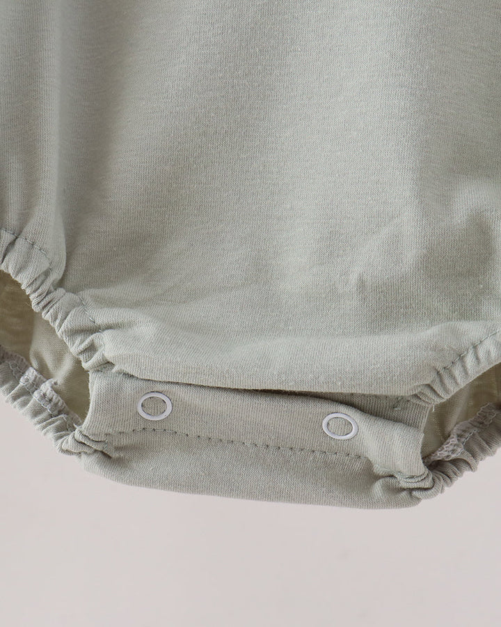 Sage green bubble romper with elastic leg gathers and snap buttons
