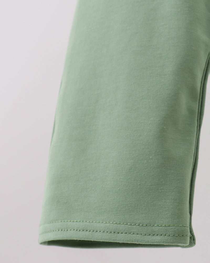 Sage green jon jon pant leg hem with double-stitched edge