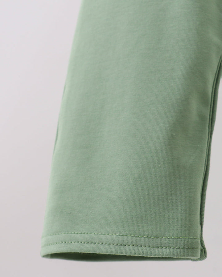 Sage green jon jon pant leg hem with double-stitched edge