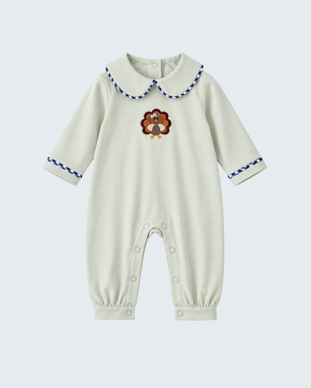 Sage long-sleeve baby romper with embroidered turkey, button snaps, and blue cuff trim
