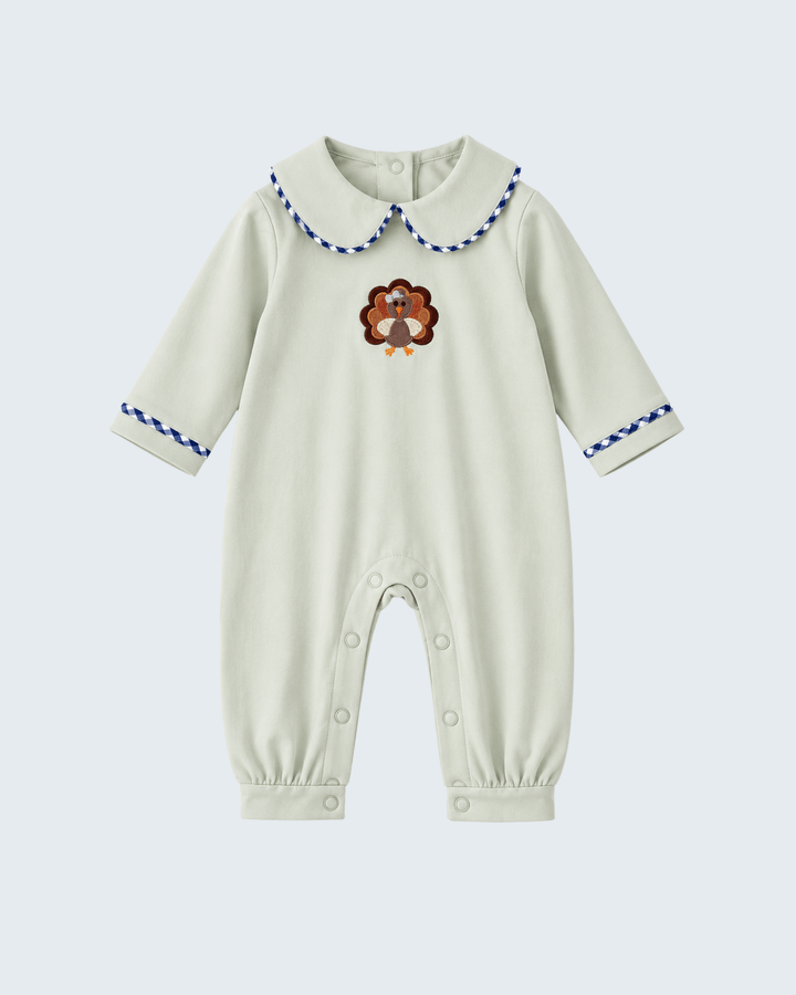 Sage long-sleeve baby romper with embroidered turkey, button snaps, and blue cuff trim