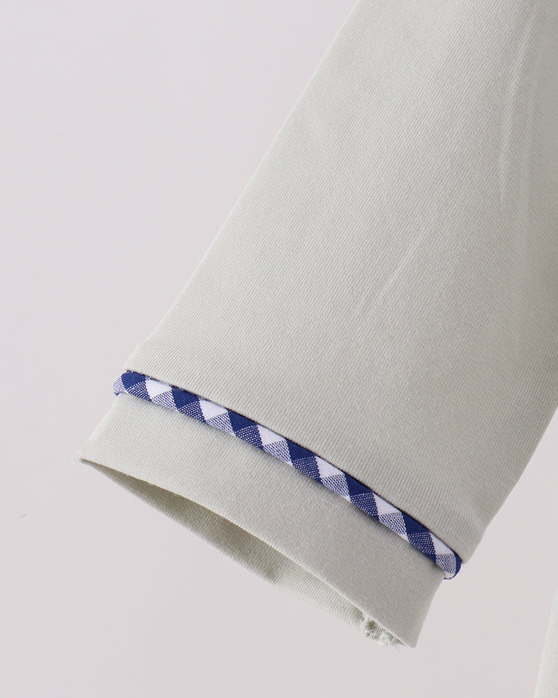 Off-white romper sleeve cuff with blue gingham trim and snap edges