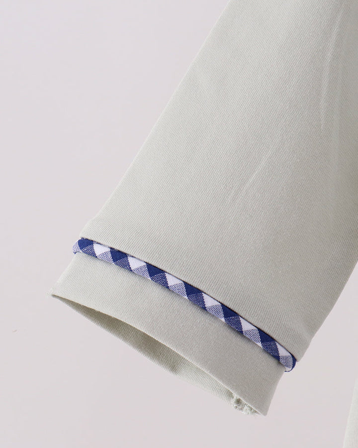 Off-white romper sleeve cuff with blue gingham trim and snap edges