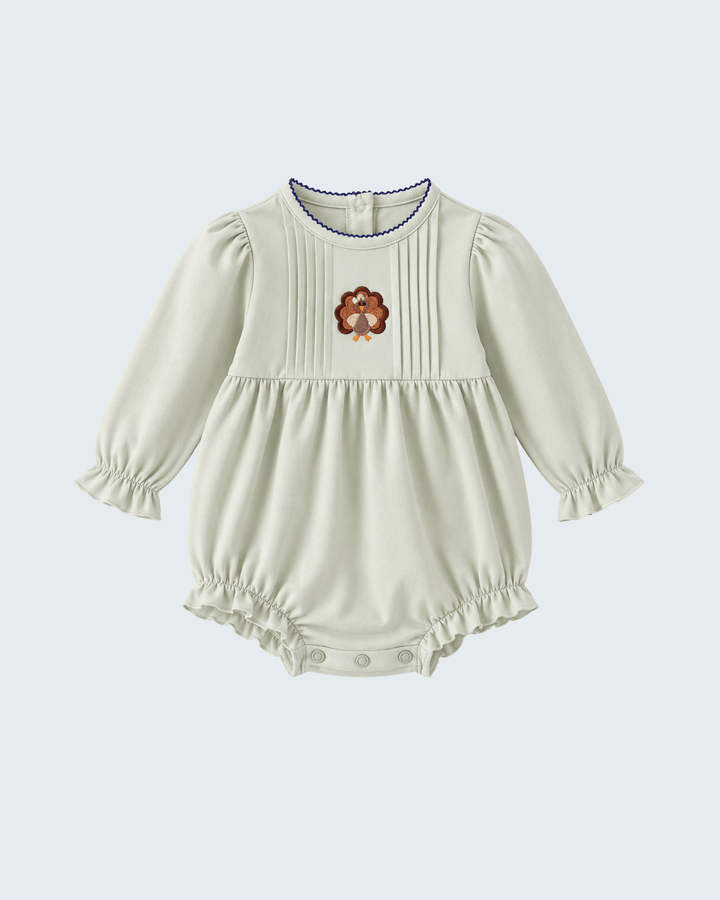 Light sage baby bubble romper with long sleeves, ribbed yoke and turkey embroidery, snap legs