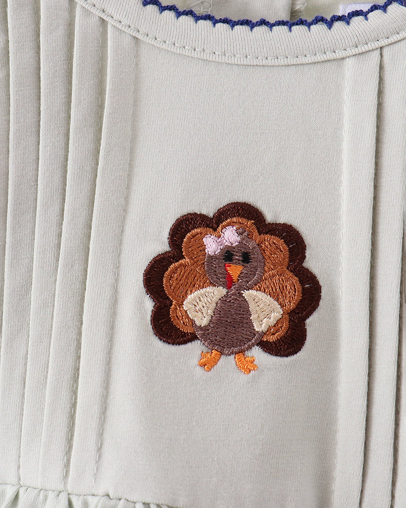White yoke with turkey applique and blue zigzag stitching