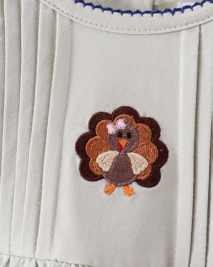 White yoke with turkey applique and blue zigzag stitching