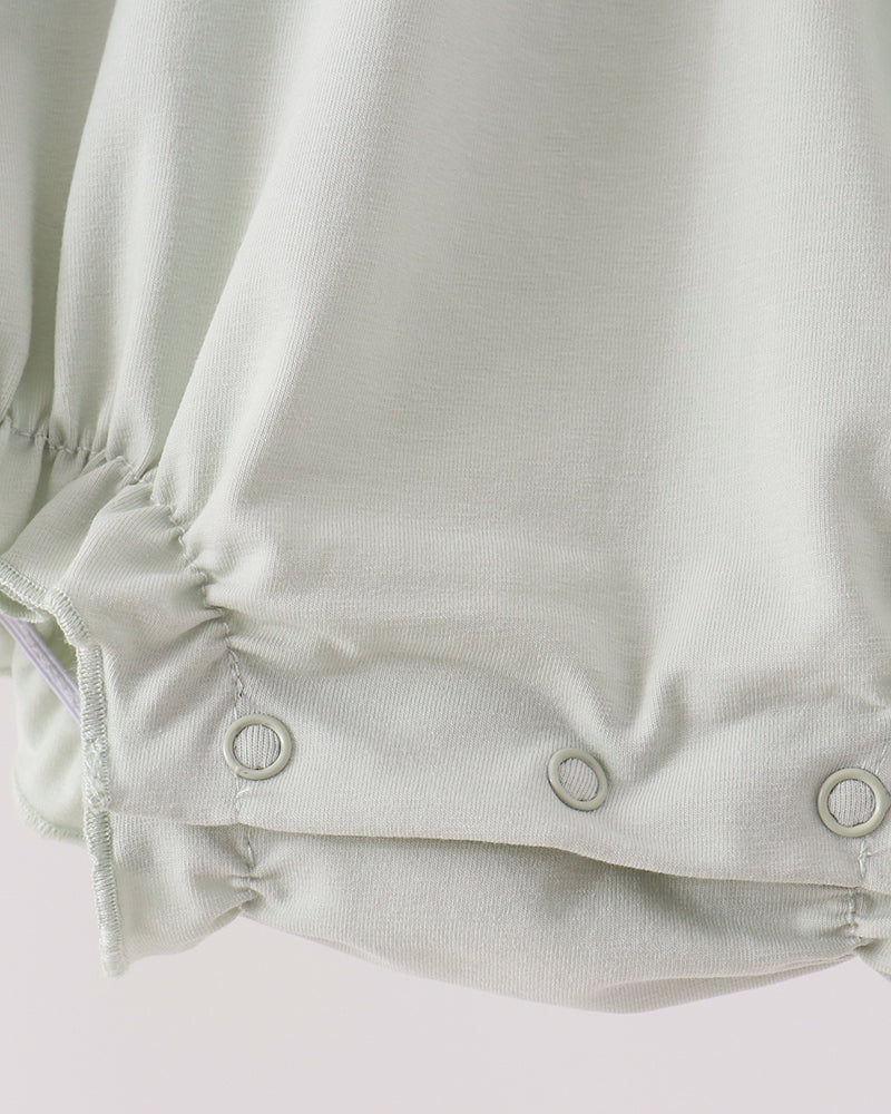 Sage green romper with snap button closure at lower back