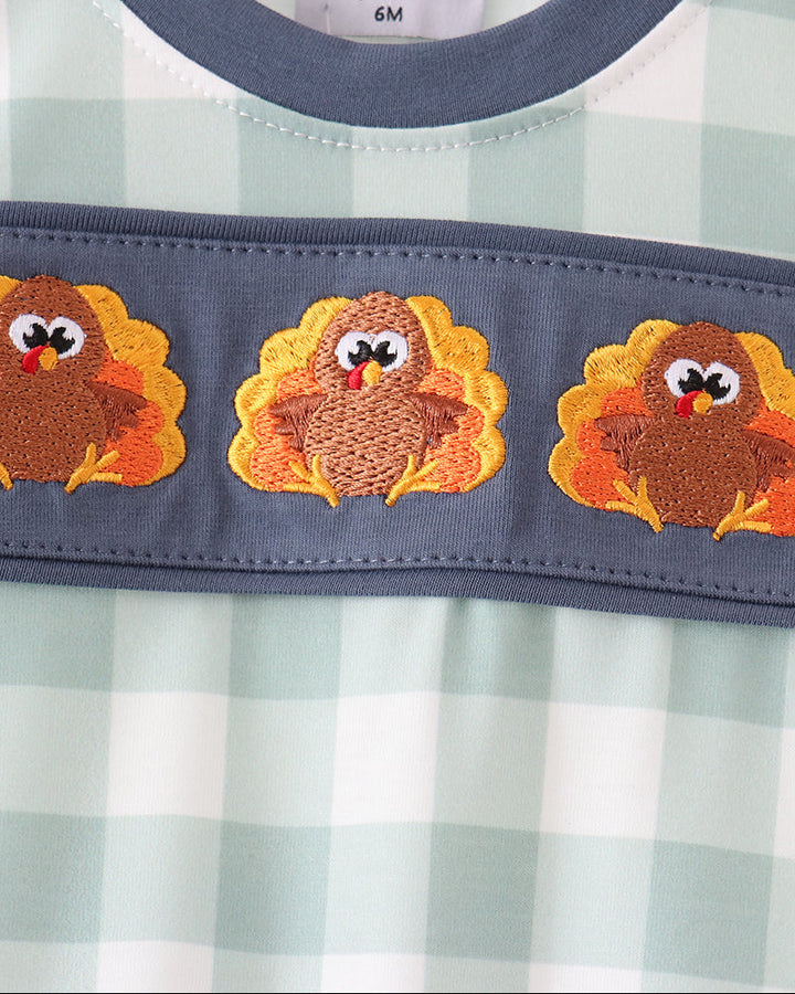 Navy baby romper yoke with three embroidered orange turkey appliques