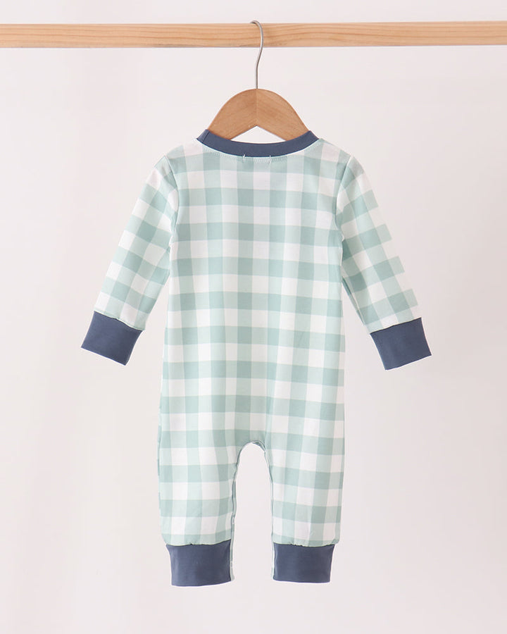 Mint and white gingham baby romper with navy long-sleeve cuffs, hanging