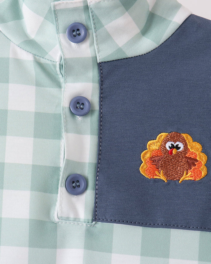 Two-piece set front close-up: mint gingham collar with navy bib and embroidered turkey