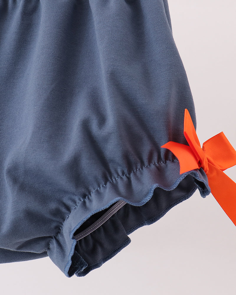 Navy bloomers with elastic leg hem and orange bow detail at side