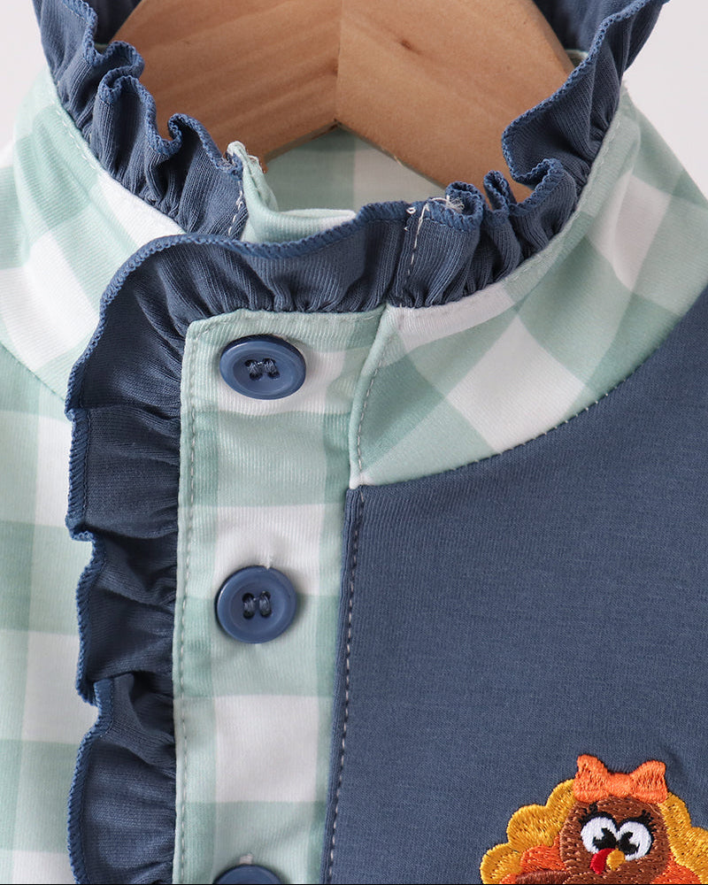 Navy button-up collar with gingham lining and embroidered turkey beak patch
