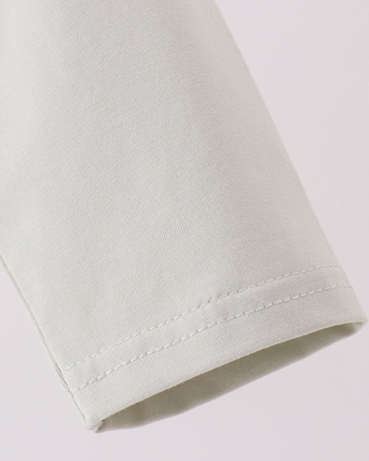 Light sage polo shirt sleeve hem with neat stitched finish