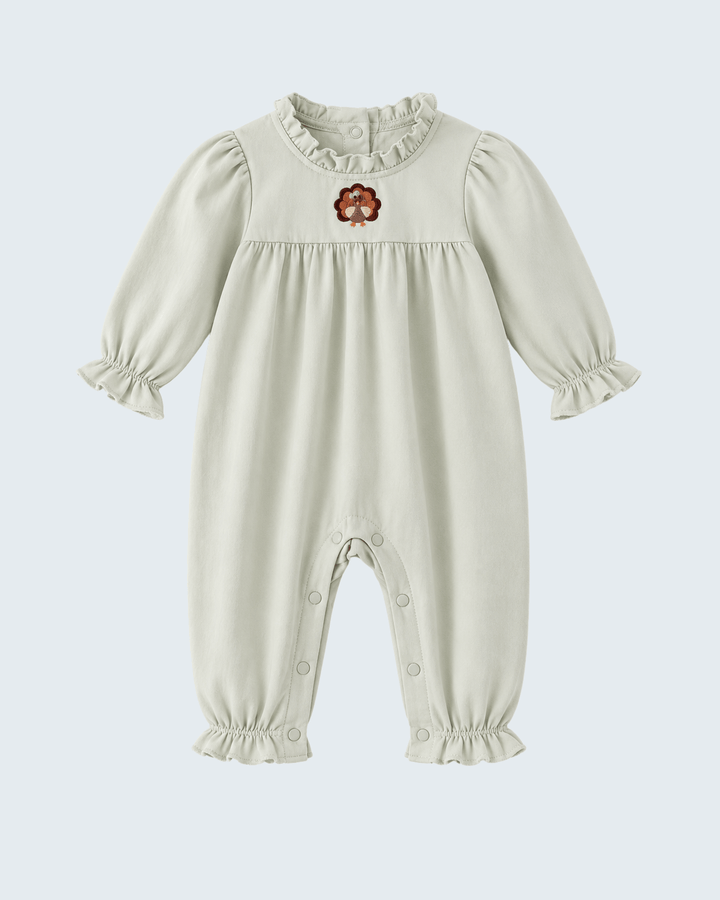 Sage baby romper with ruffled neck and embroidered turkey motif on chest, long sleeves.