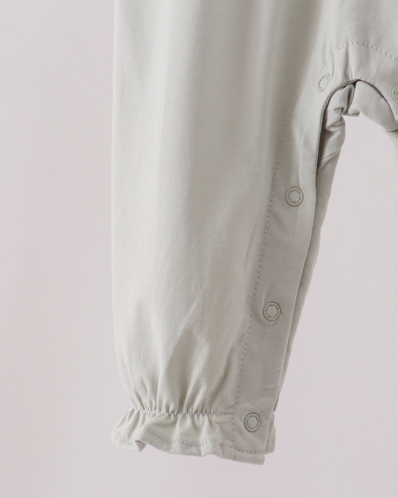 Light baby romper with snap buttons and cuffed long sleeves, front detail