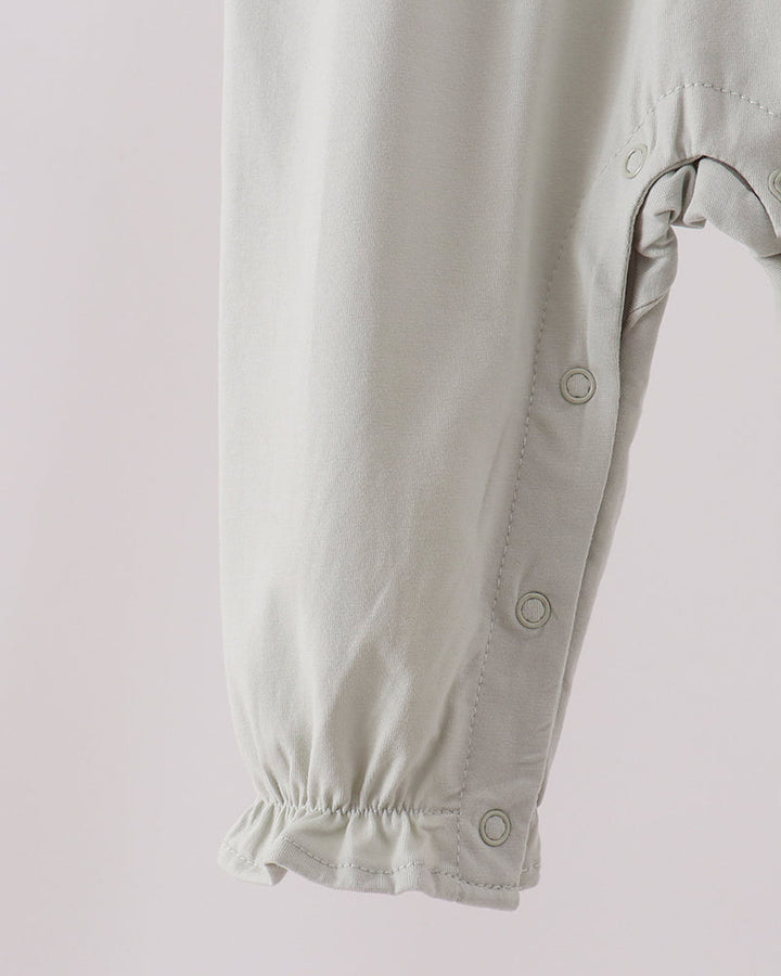 Light baby romper with snap buttons and cuffed long sleeves, front detail