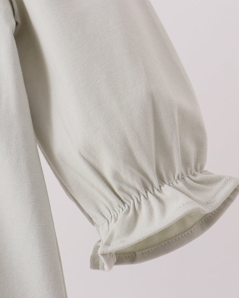 Light baby romper sleeve with elastic cuff and gathered hem, side close-up