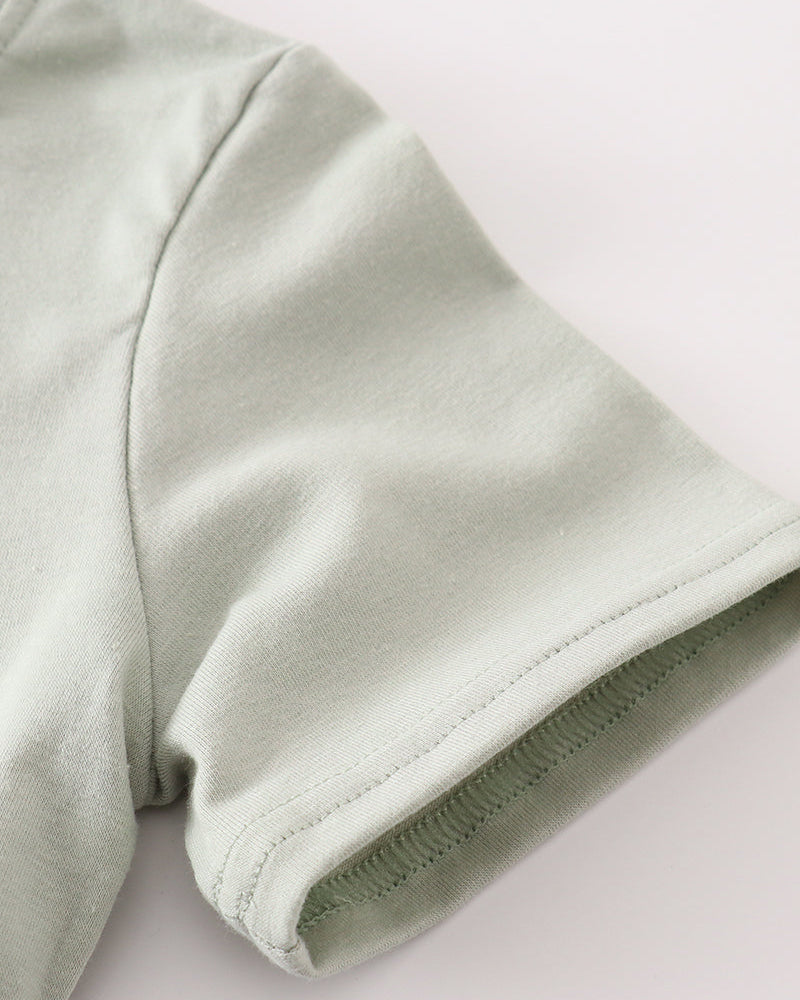Sage green fabric on light grey background