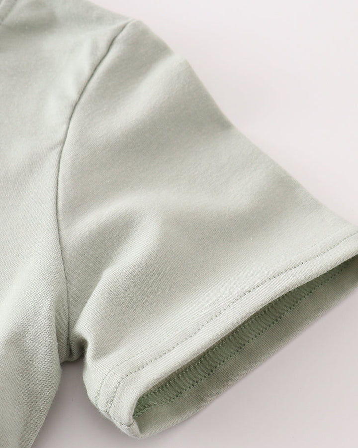 Sage green fabric on light grey background