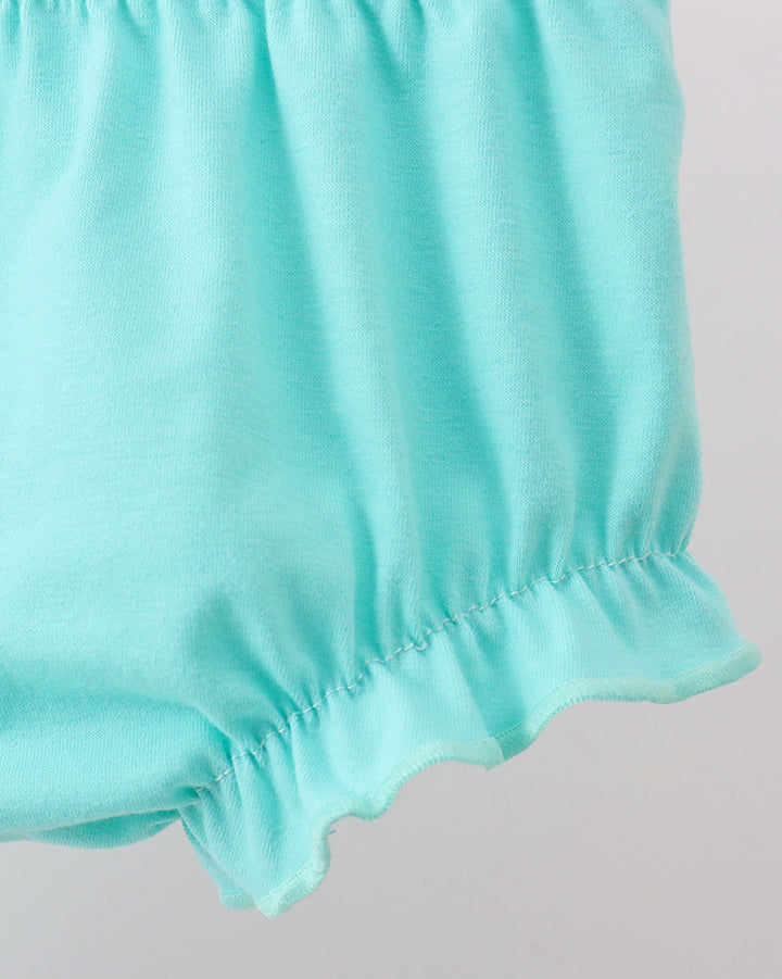 Close-up of light blue shorts on a plain background