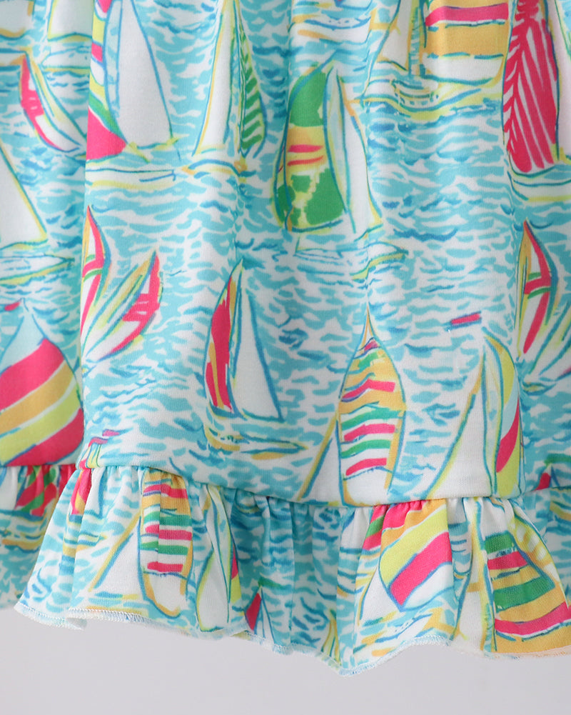 Colorful dress with sailboat pattern on a white background