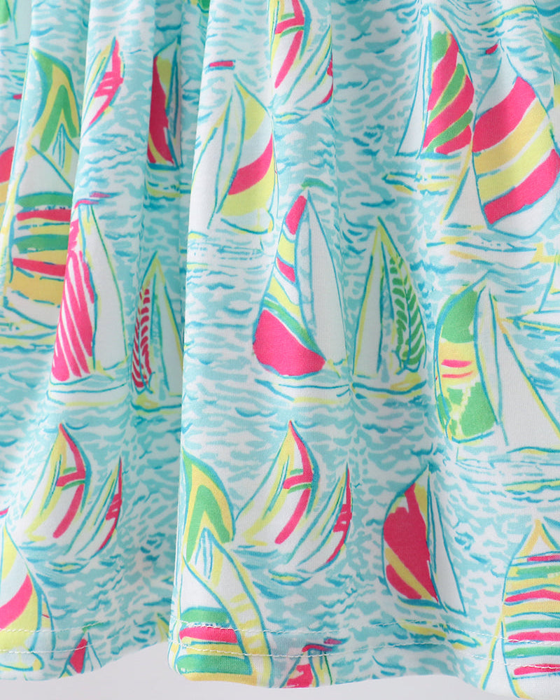 Colorful curtain with sailboat pattern on a light blue background