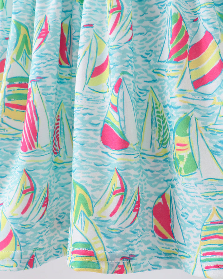 Colorful curtain with sailboat pattern on a light blue background