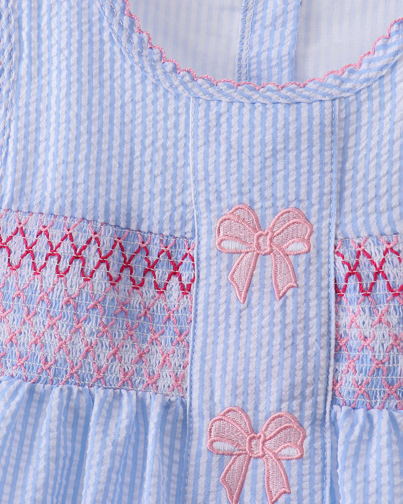 Light blue and white striped dress with pink bows and red stitching details.