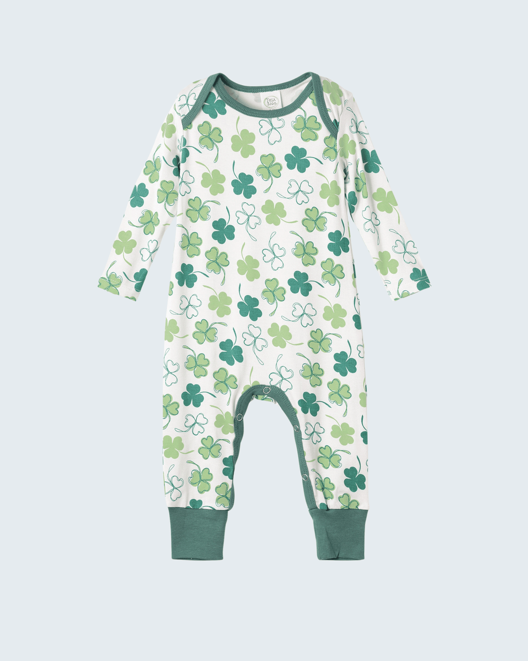 Baby bamboo romper with long sleeves, white base, green clover pattern, footed legs