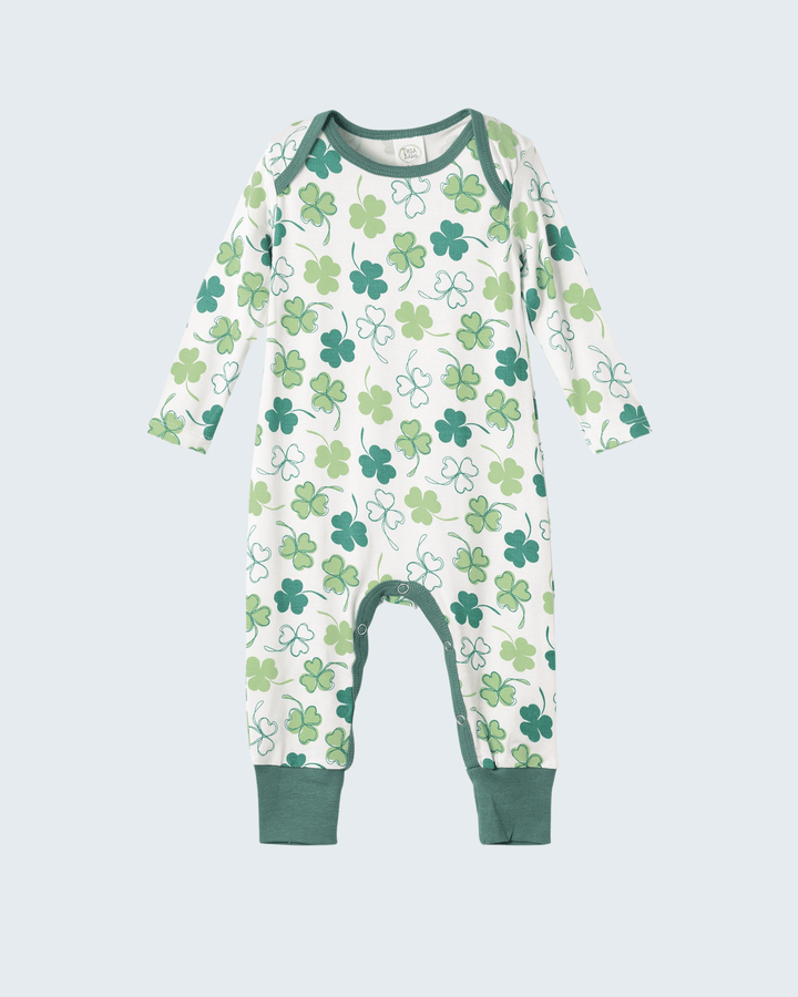 Baby bamboo romper with long sleeves, white base, green clover pattern, footed legs