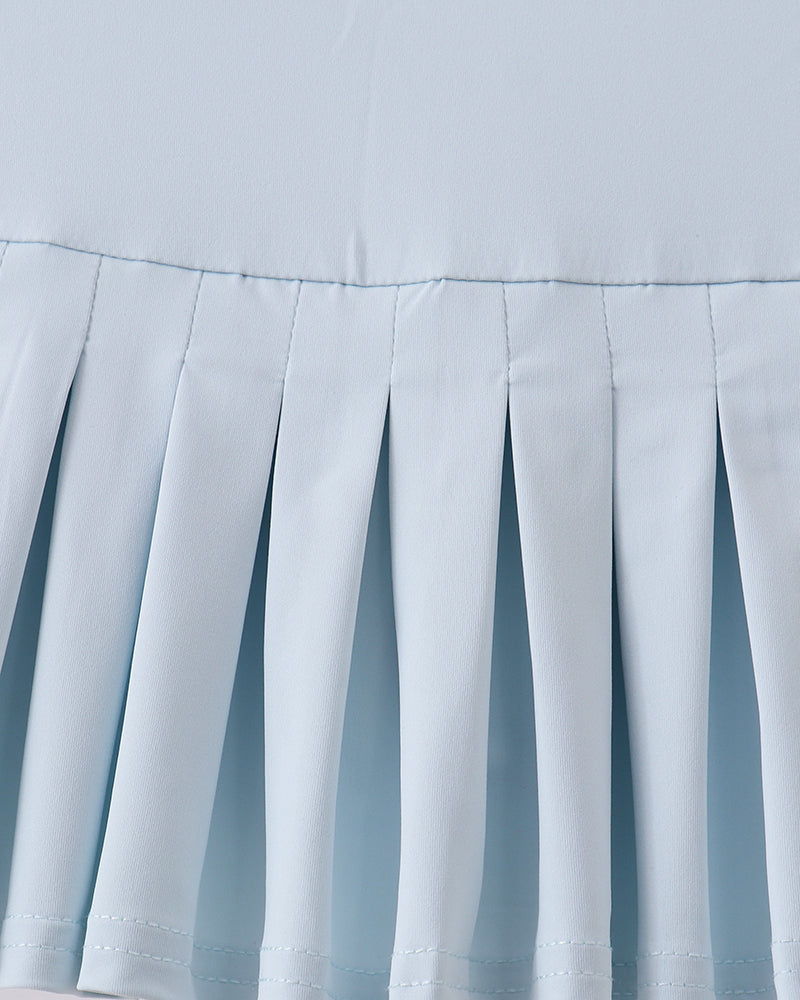 Close-up of a light blue pleated fabric texture on a white background