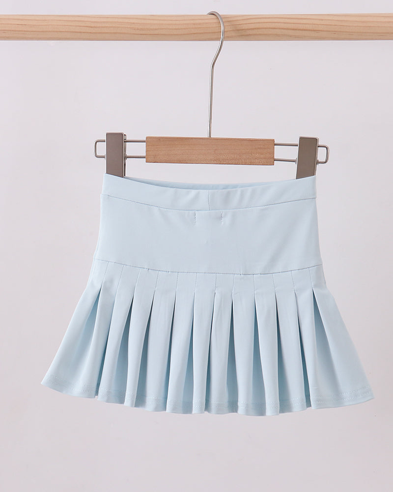 Light blue pleated skirt hanging on a wooden hanger against a light background