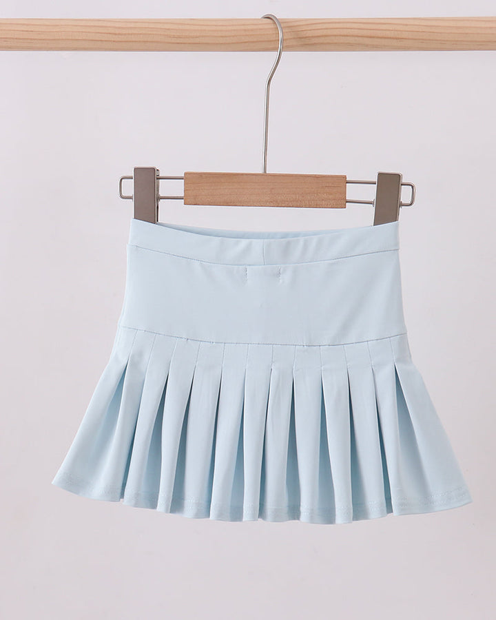 Light blue pleated skirt hanging on a wooden hanger against a light background