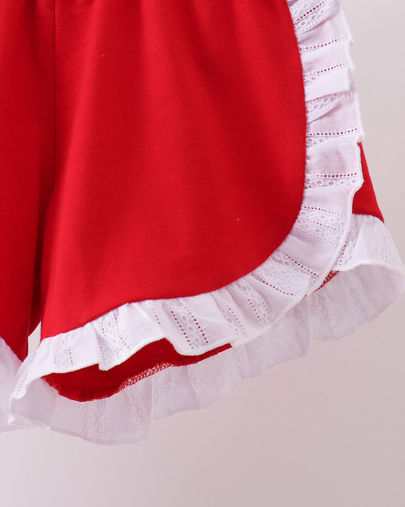 Red fabric with white lace trim on a plain background