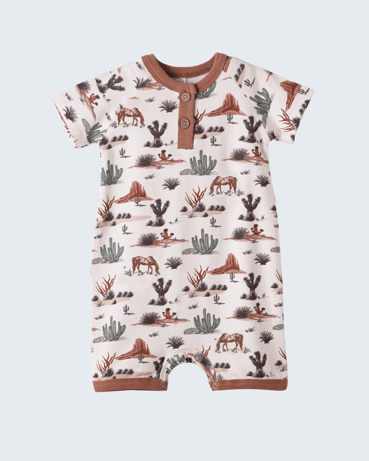 Baby romper with desert animal print on a white background