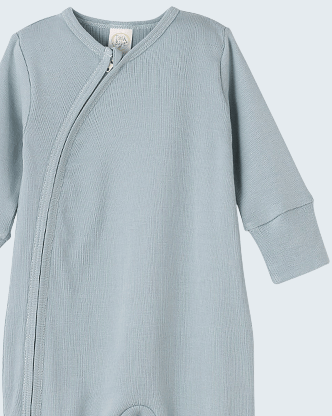 Light blue cotton romper with front diagonal zipper and long sleeves