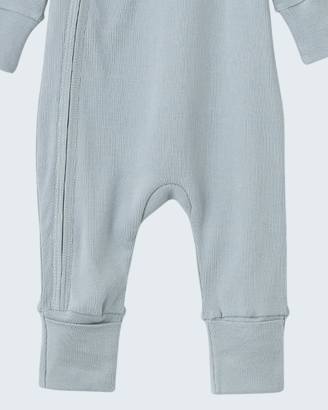 Light blue cotton footed romper with diagonal zipper and ribbed ankle cuffs